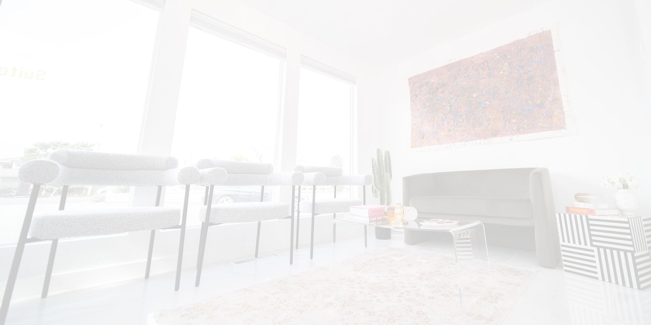 Modern waiting area with plants and artwork.