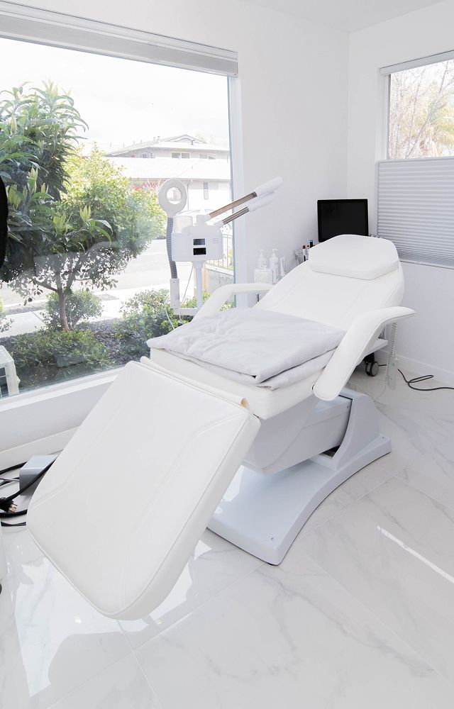 Modern aesthetic treatment room with adjustable chair.