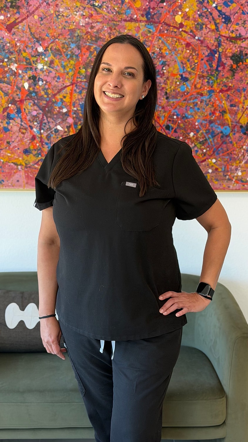 Female healthcare professional in black scrubs.
