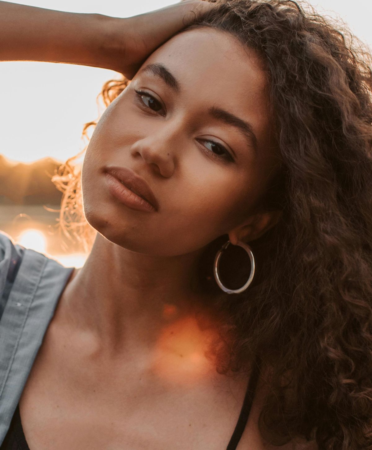 Young woman with long brown hair and blue eyes.
