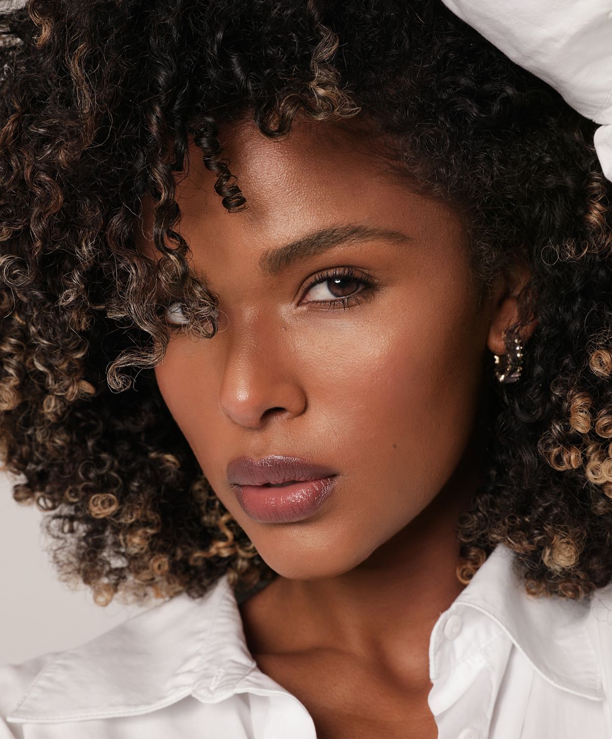 Close-up of woman with curly hair.
