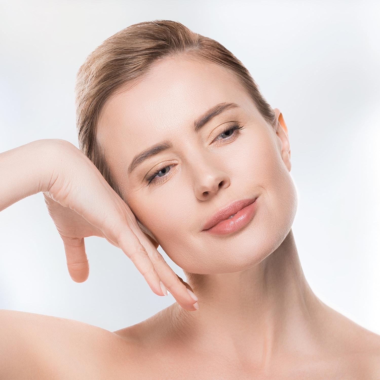 Woman with natural makeup and soft expression.