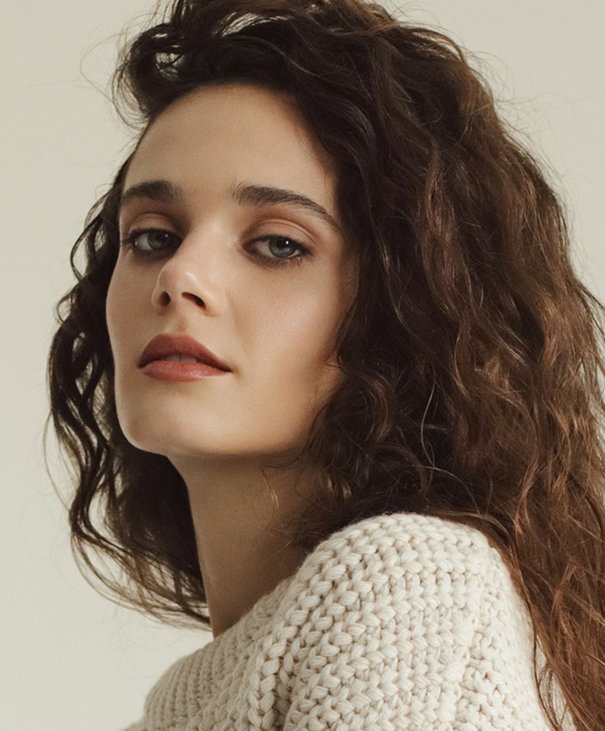 Young woman with long brown hair and blue eyes.