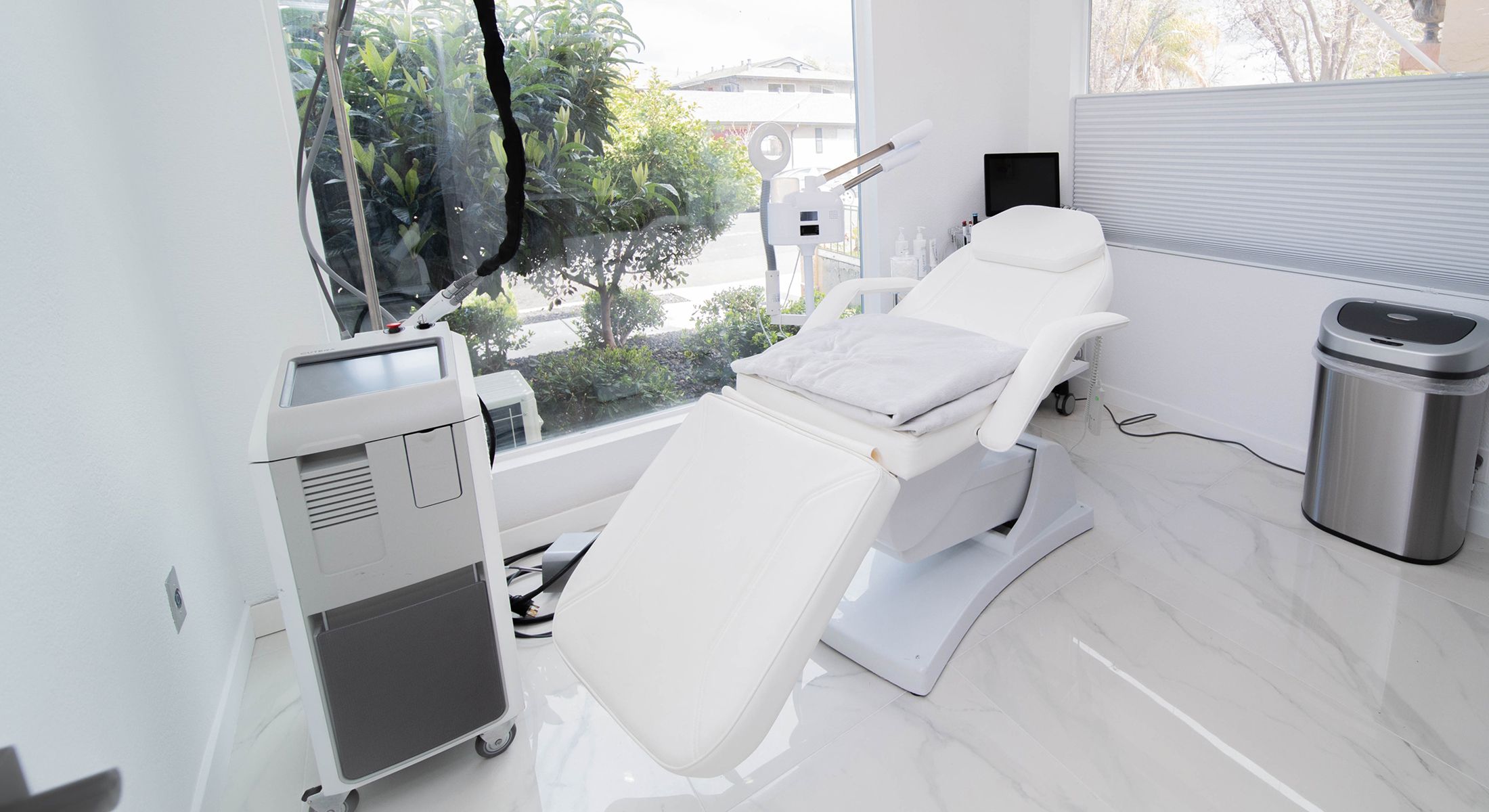 Modern aesthetic treatment room with equipment.