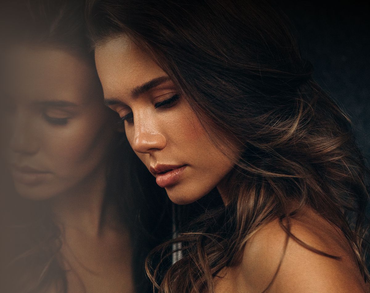 Young woman with long hair in sunlight.