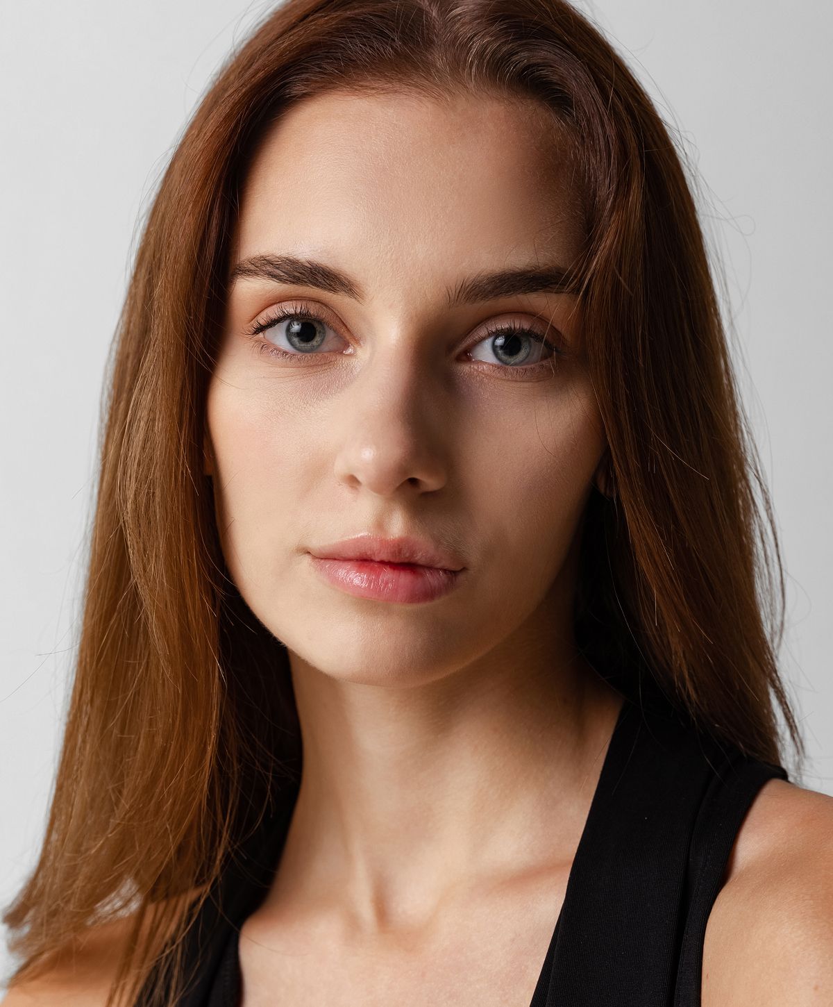 Woman with long hair looking over her shoulder.