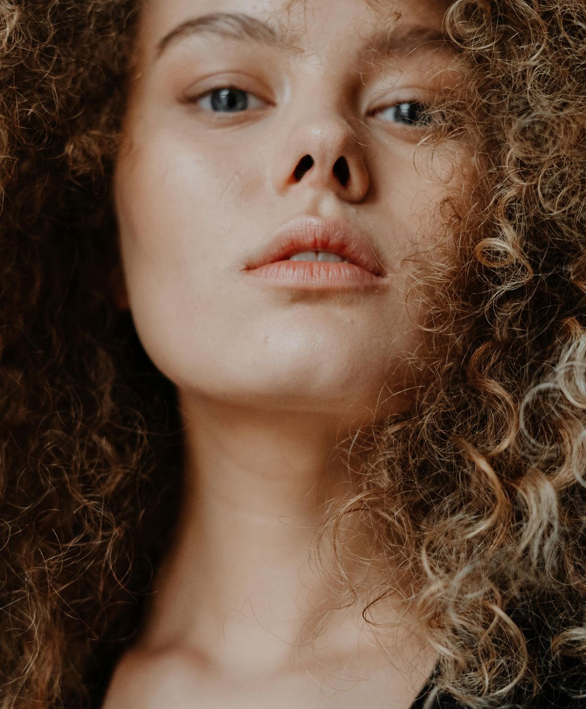 Close-up of a person with curly hair.
